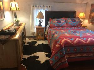 a bedroom with a bed and a table with a lamp at Holiday Lodge Bed and Breakfast in Banff