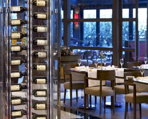 a restaurant with tables and chairs and a wine rack at Surmeli Istanbul Hotel in Istanbul
