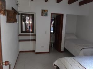 A bed or beds in a room at Cemandy Hostal