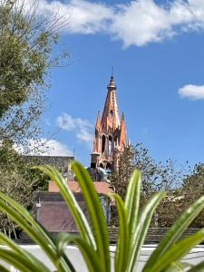 
a tall building with a clock on top of it at Hotel Casa San Miguel in San Miguel de Allende
