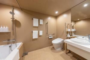 
a bathroom with a sink, toilet and bathtub at toggle hotel suidobashi TOKYO in Tokyo
