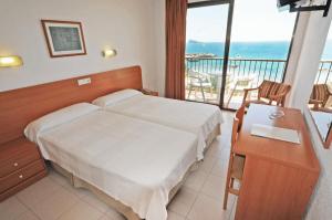 Postel nebo postele na pokoji v ubytování Hotel Montemar