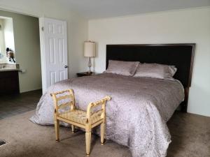 a bedroom with a large bed and a chair at The Villa - Amazingly Comfortable King Beds in Alpine