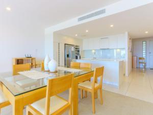 a kitchen and dining room with a table and chairs at Azura Ocean View Holiday Apartment in Kingscliff