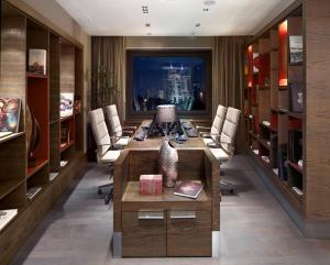 an office with a long desk with chairs and a table at Surmeli Istanbul Hotel in Istanbul