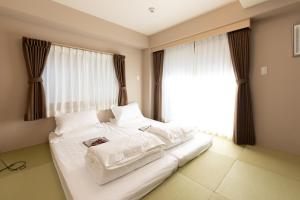 Postel nebo postele na pokoji v ubytování 灯光旅館 Light hotel