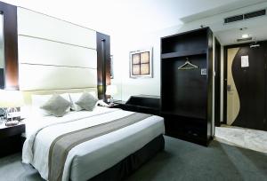 Postel nebo postele na pokoji v ubytování Serela Waringin by KAGUM Hotels