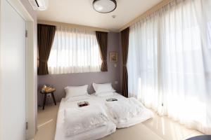 Postel nebo postele na pokoji v ubytování 灯光旅館 Light hotel