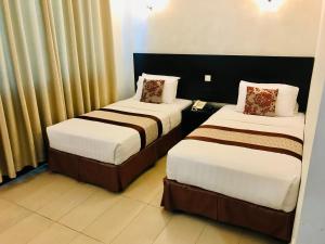 Voodi või voodid majutusasutuse My Inn Hotel Lahad Datu, Sabah toas