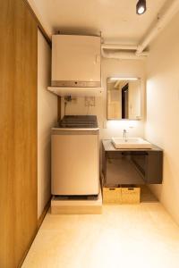 a small kitchen with a sink and a refrigerator at NIYS apartments 07 type in Tokyo