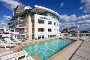 a hotel with a swimming pool in front of a building at Southbank Modern Luxe Apartment in Brisbane