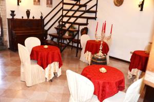 a dining room with tables and chairs and a red carpet at Residenza Di Via Piccardi in Gubbio