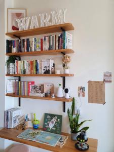 a desk with bookshelves on a wall at Warm & Cozy Inn in Hengchun