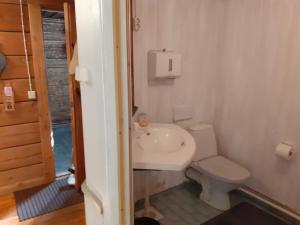 a small bathroom with a toilet and a sink at Miekkalan Saunatupa in Lappeenranta