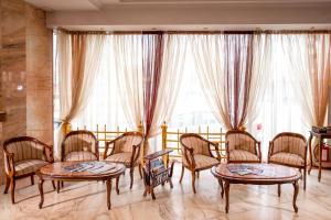 a room with chairs and tables and large windows at Eurohotel in Lviv