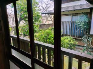 a view from a window of a balcony at Guesthouse Sakichi in Beppu