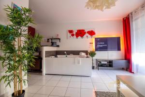 a living room with plants and a tv on the wall at 123home-Loft & spa in Montévrain