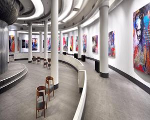 a room with chairs and paintings on the walls at Surmeli Istanbul Hotel in Istanbul