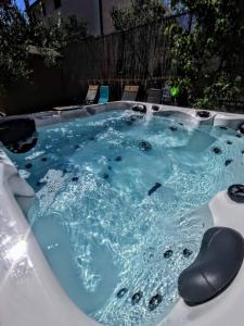 a hot tub with blue water in a backyard at Holiday Home Istra with JACUZZI in Medulin