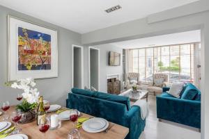 a living room with two blue couches and a table at Lovely 4 Bedroom townhouse in Bath
