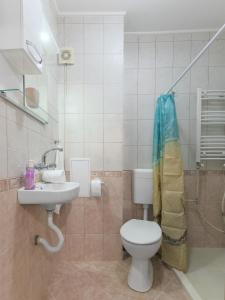 a bathroom with a toilet and a sink at Like home in Burgas