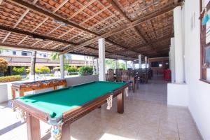 a pool table in the middle of a room at Pousada Do Inglês in Jacumã