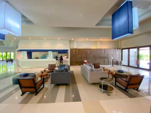 a living room with couches and chairs at TUI BLUE Khao Lak Resort in Khao Lak