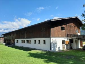 a large barn with a large wooden roof at Simiterhof Lavant in Lavant