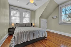 a bedroom with a bed and two windows at Oakley Square 3BR Charmer - Total Walkability home in Cincinnati