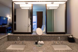 a bathroom with two sinks and a mirror at Hard Rock Hotel & Casino Biloxi in Biloxi