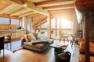 a living room with a couch and a table at ZillerLodge in Uderns