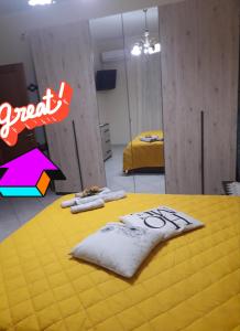 a room with a yellow table with towels on it at Gio's house in Collemeto