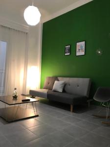 a living room with a couch and a lamp at Midway Point Apts in Heraklio
