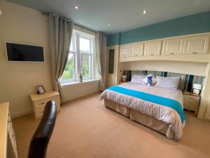 a bedroom with a large bed and a window at Park House in Carnoustie