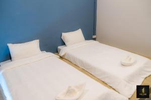 Postel nebo postele na pokoji v ubytování The one hotel สวนผึ้ง