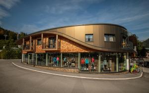 a building with a store front with glass windows at Herbst Wohnerlebnis in Lofer