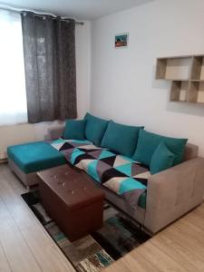 a living room with a couch and a table at Mountain Loft in Piatra Neamţ