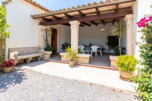 a patio with a wooden pergola and a bench at Villa Rosa in Pollença