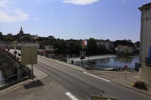 an empty street with a river and a bridge at Gray centre ville avec vue sur Saône in Gray