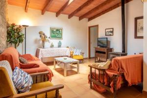 a living room with a couch and a tv at Villa Rosa in Pollença