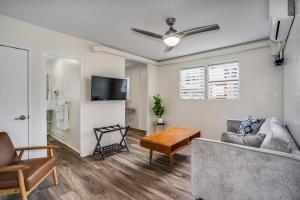 a living room with a couch and a table at Aloha Suites Waikiki in Honolulu