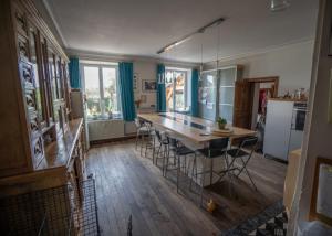a kitchen with a large wooden table and chairs at Le Bonheur Cristallin in Rochefort