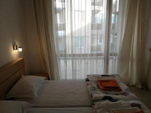 a bed in a room with a large window at Cozy family villa 500m. from the beach in Byala +34 photos