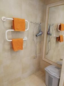 a bathroom with a shower with orange towels at Cozy family villa 500m. from the beach in Byala