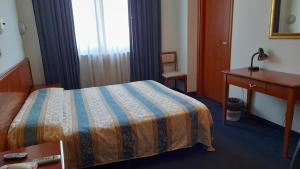 A bed or beds in a room at Hotel Tortorina