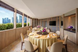 a conference room with tables and chairs and a tv at PARKROYAL COLLECTION Marina Bay, Singapore in Singapore