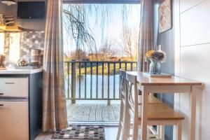 a kitchen with a view of a balcony at The Treehouse - Sleeps 4 in Old Leake