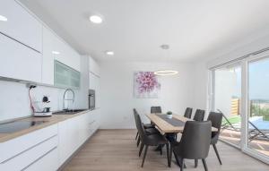 a kitchen and dining room with a table and chairs at Villas Alfa & Omega in Klis