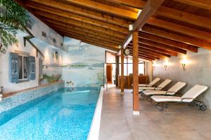 an indoor swimming pool with a painting on the wall at Landgasthof Karner in Frasdorf