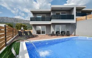 a house with a swimming pool in front of a house at Villas Alfa & Omega in Klis